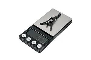 A black BetaFPV Air Canopy component resting on a digital scale showing a weight reading.
