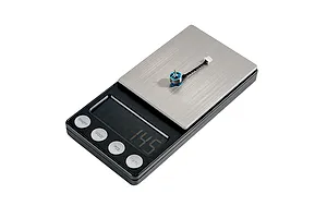 A single BetaFPV 0702SE II brushless motor placed on a digital scale to show its weight.