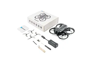 BetaFPV Aquila20 HD drone kit including the drone, spare propellers, battery, tools, and original packaging box on a white background.