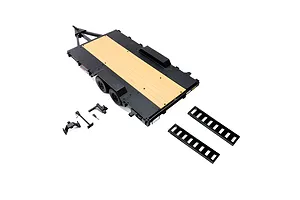 Axial 1/10 scale RC flat bed vehicle trailer with black frame, tan deck, two ramps, and hitch accessories on a white background.