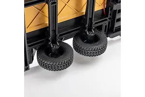 Close-up of the black plastic suspension and rubber tires on an Axial 1/10 scale flat bed vehicle trailer.