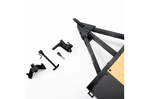 Axial 1/10 scale flat bed vehicle trailer showing the hitch assembly, jack stand, and mounting components on a white background.