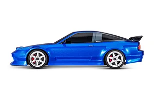 Side profile of a blue Traxxas Nissan 240SX RC drift car with white wheels and black tinted windows on a white background.