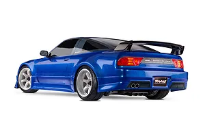 Rear three-quarter view of a blue Traxxas Nissan 240SX RC drift car with white wheels and a rear spoiler against a white background.
