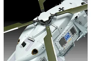 Close-up of a 1/72 scale plastic model NH90 helicopter showing the rotor assembly, fuselage, and German Navy markings.