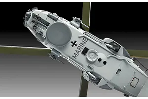 A bottom-up view of a 1/72 scale Revell NH90 NFH Navy helicopter model, showing the landing gear, radar dome, and German Marine markings.