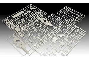 Several light grey plastic model kit sprues for a helicopter model, including fuselage halves and small components, arranged on a dark background.