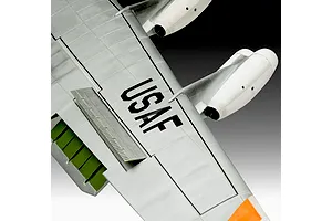 Close-up of a plastic model aircraft wing with USAF markings, white engine pods, and green flap details.