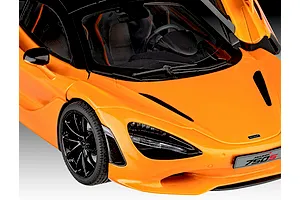 Close-up of a 1/24 scale orange McLaren 750S model car showing the front hood, windshield, and driver side door.