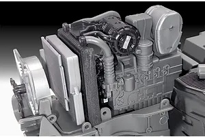 Close-up of the unpainted plastic engine block and radiator assembly for a Revell 1/24 scale Fendt 728 Vario tractor model kit.
