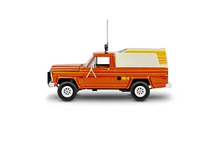 Side view of a 1/24 scale Revell Jeep J-10 pickup truck model with a camper shell, painted metallic orange with yellow stripes.