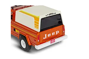 Rear three-quarter view of a 1/24 scale Revell Jeep J-10 pickup model kit with a white camper shell and orange body.