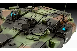 Close-up of the turret top of a camouflaged Leopard 2A7A1 tank model, showing hatches, antennas, and a machine gun mount.