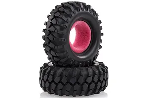 Two black rubber RC rock crawler tyres stacked on top of each other, featuring aggressive tread patterns and bright pink foam inserts.