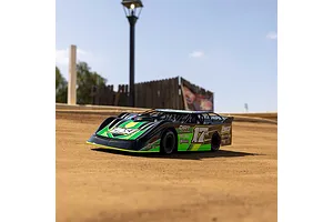 A Losi 22S Dirt Late Model RC car in green and black livery sitting on a dirt track outdoors.