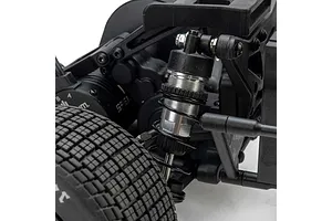 Close-up of the rear suspension and shock absorber on a Losi 22S RC car, showing the coil-over shock, tire tread, and chassis components.