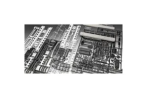 Several plastic model kit sprues for a train set, including black and white parts for carriages and locomotive components.