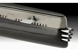Close-up of the bow section of a plastic model submarine kit, showing the hull, a small fin, and torpedo tubes.