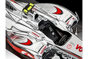 Top-down view of a silver McLaren Formula 1 model car showing cockpit detail and sponsor decals.