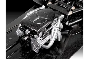 Close-up of a detailed scale model Formula 1 engine with a Mercedes-Benz logo on the black engine cover.