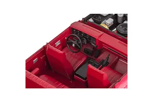 Interior view of a red 1/25 scale model GMC Jimmy showing the dashboard, steering wheel, and red bucket seats.