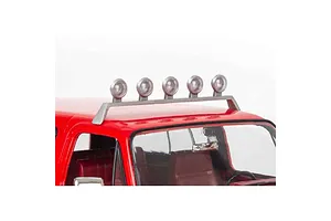 Close-up of a red model car roof featuring a silver light bar with five round spotlights mounted above the windshield.
