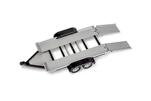 A 1/25 scale model car trailer with diamond plate deck, black fenders, and dual axles, viewed from a high angle.
