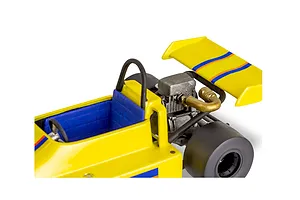 Close-up of a yellow model go-kart with a blue seat, rear engine, and spoiler, part of the Revell 1978 Chevy 4X4 model kit.