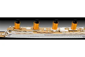 A close-up side view of a Revell 1/600 RMS Titanic model kit showing the deck, lifeboats, and four iconic yellow and black funnels.