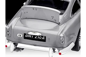 Close-up of the rear of a silver Aston Martin DB5 model car showing the license plate BMT 216A and an open rear bulletproof shield.