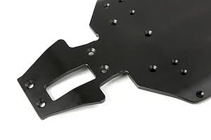 A close-up view of a black anodized aluminium RC car main chassis plate with various mounting holes and a rectangular cutout.
