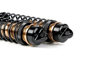 Two Rovan aluminium adjustable rear shock absorbers for RC cars, featuring bronze-coloured bodies and black springs, isolated on a white background.
