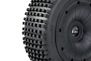 Close-up of a black 1/5 scale RC buggy tyre with square tread blocks mounted on a black closed-face beadlock rim.