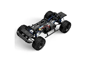 High-angle studio shot of an MJX RC Allrock 1/8 scale rock crawler chassis without a body shell, showing the motor, suspension, and drivetrain.