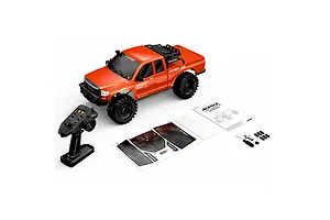 MJX Hyper Go Allrock 1/8 scale RC rock crawler in orange with remote control, user manual, sticker sheet, and included tools on a white background.