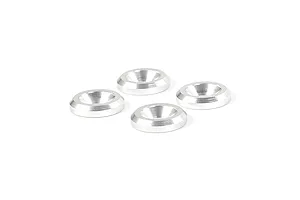 Four silver-coloured metal countersunk washers arranged on a white background.