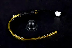 Rovan Baja fuel system kit including fuel tubing, a fuel filter, and a black rubber tank cap seal on a dark background.