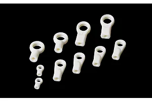 A collection of ten white plastic RC rod ends of varying sizes arranged on a black background.