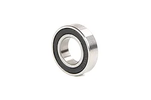 A single metal ball bearing with a black rubber seal on one side, isolated on a white background.