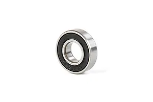 A single metal ball bearing with a black rubber seal, shown at an angle against a white background.