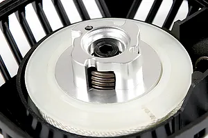 Close-up of a Rovan pull start assembly showing the metal claw, white plastic spool, and black housing.