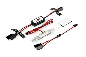 Rovan RC light controller kit featuring a control module, a silver LED light bar, wiring harnesses with labeled connectors, and adhesive mounting pads.