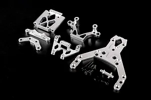 A set of silver aluminium RC car front bulkhead components and an upper plate with mounting hardware on a black background.