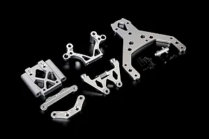 A set of silver aluminium RC front bulkhead components and an upper plate with mounting hardware on a black background.