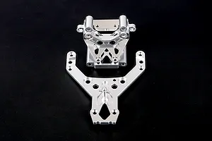 Silver aluminium front bulkhead set with upper plate for Rovan RC vehicles, shown on a dark background.