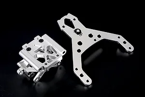 Rovan silver aluminium front bulkhead set with upper plate for RC cars, shown on a black background.
