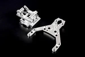 Rovan silver aluminium front bulkhead set including the main bulkhead assembly and a separate upper plate on a black background.