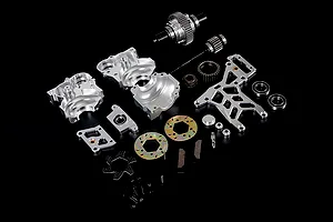 A Rovan 1/5 scale Baja silver aluminium gear differential transmission assembly kit laid out on a black background.
