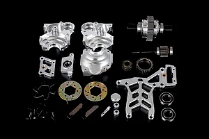A collection of silver aluminium RC car transmission and differential parts laid out on a black background.