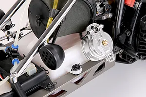 A silver aluminium fuel tank cap installed on a white plastic fuel tank of an RC vehicle.